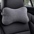 Gray car headrest pillow on a car seat