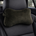Dark green car headrest pillow on a black car seat