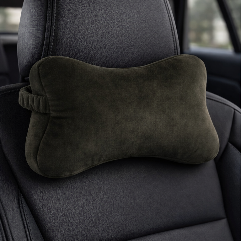 Dark green car headrest pillow on a black car seat